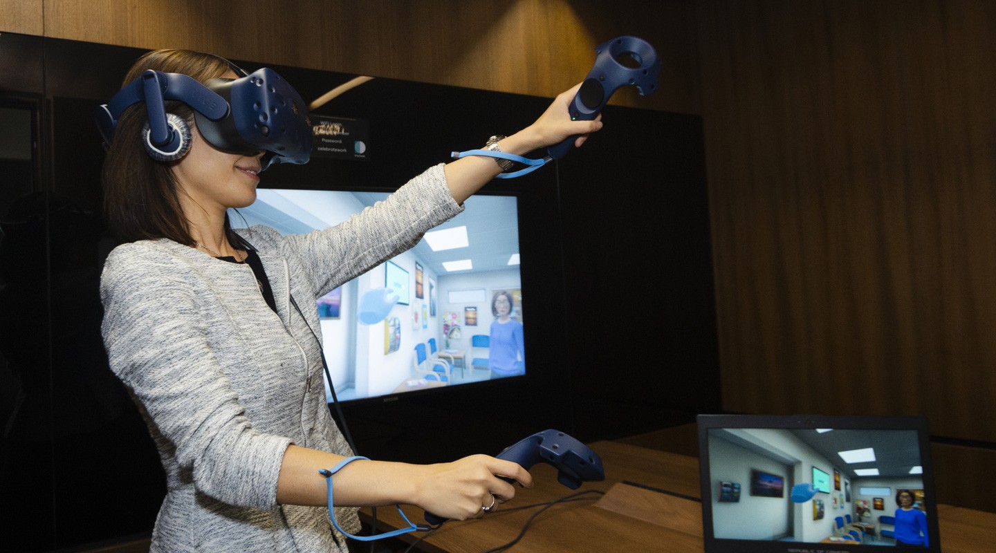 two people sitting on a ledge talking
